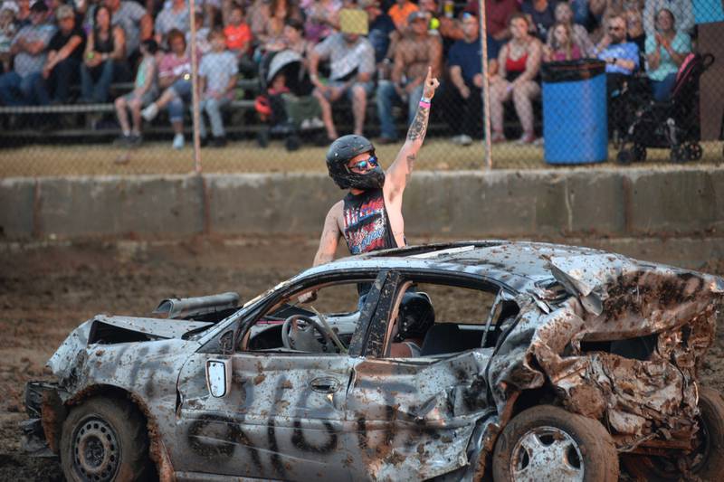 Jaden Muntean of Sterling celebrates after finishing the Open Wire heat at the Ogle County Fair on Saturday, Aug. 5, 2023. His cousin, Brenton Muntean, was the driver.