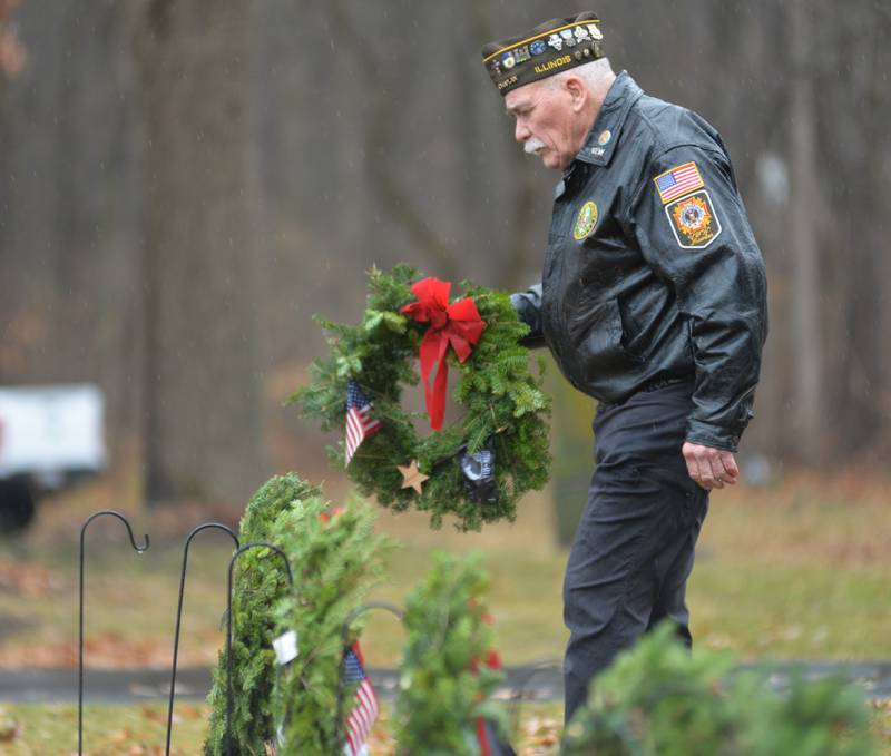 Oregon VFW member and Vietnam War veteran John Tuttle of Oregon, carries a military division wreath at the start of he Wreaths Across America event at Daysville Cemetery. east of Oregon, on Saturday, Dec. 16, 2023.