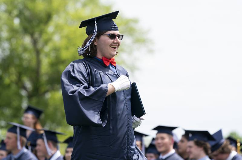 Graduating senior Lane Wilkinson celebrates after receiving a diploma during a graduation ceremony for the class of 2022 on Saturday, May 14, 2022, at Cary-Grove High School in Cary.