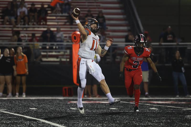Minooka’s Gavin Dooley makes a pass on the run against Bolingbrook. Friday, Aug. 26, 2022, in Bolingbrook.