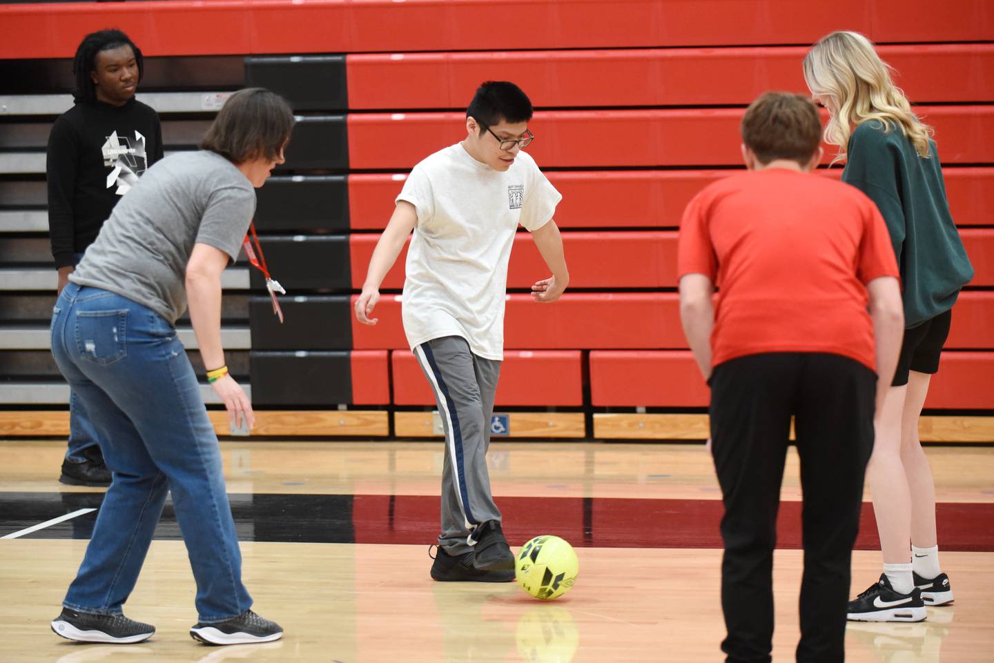 Bradley-Bourbonnais High School student Adrian Zaragova (center) dribbles the ball while playing soccer during an adapted PE class Friday, April 4, 2025.
