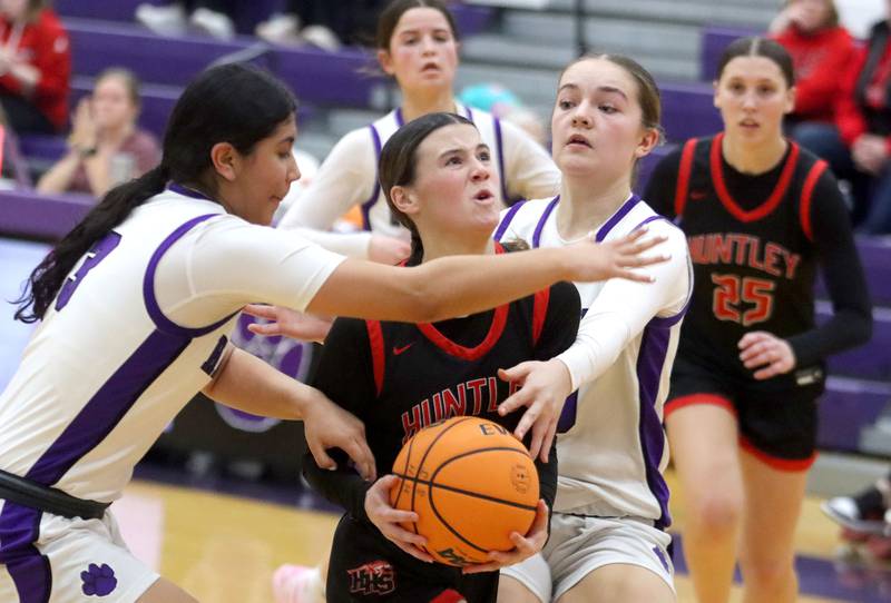 Huntley’s Aubrina Adamik, center, fights her way to the hoop in varsity girls basketball on Wednesday, Feb. 11, 2026, at Hampshire High School in Hampshire.