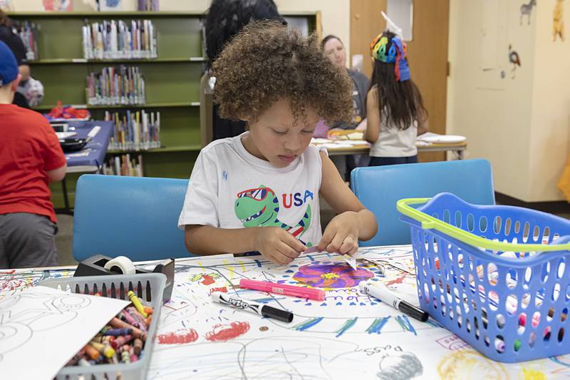 Matthew Sandoval, 5, of Dixon decorates a craft Wednesday, July 3, 2024 during the crafts with the Petunia royalty at the Dixon library.