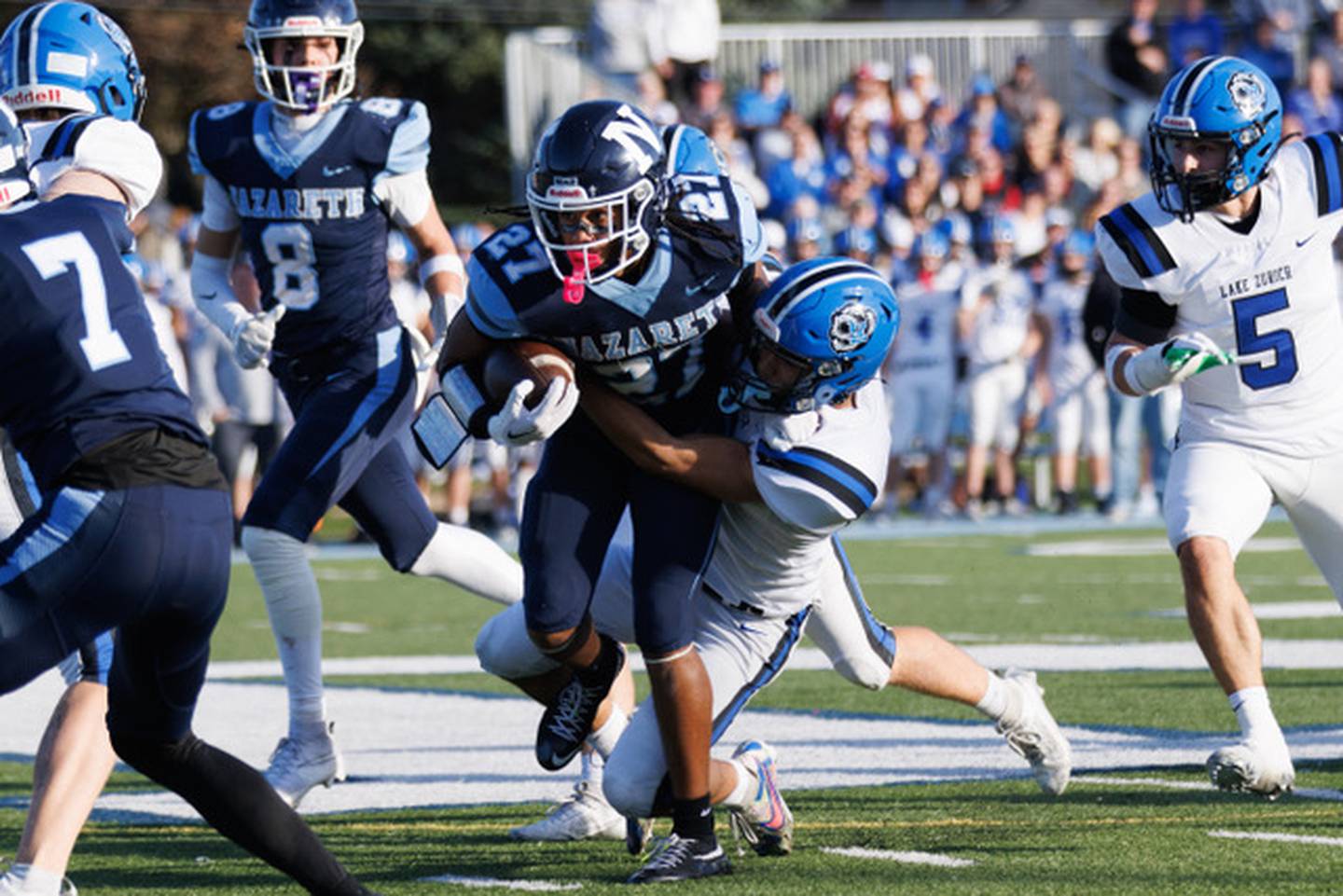 Nazareth's Charles Calhoun rushes the ball during Saturday's Class 6A quarterfinal with Lake Zurich.