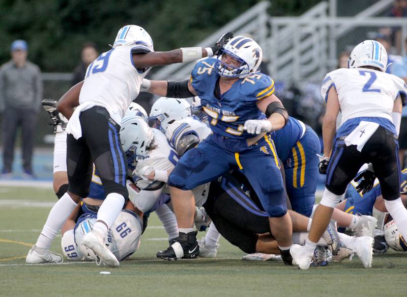 St. Charles North’s Genesis Holloman (left) and Wheaton North’s Matt Rambasek (right) battle during a game in Wheaton on Friday, Sept. 8, 2023.
