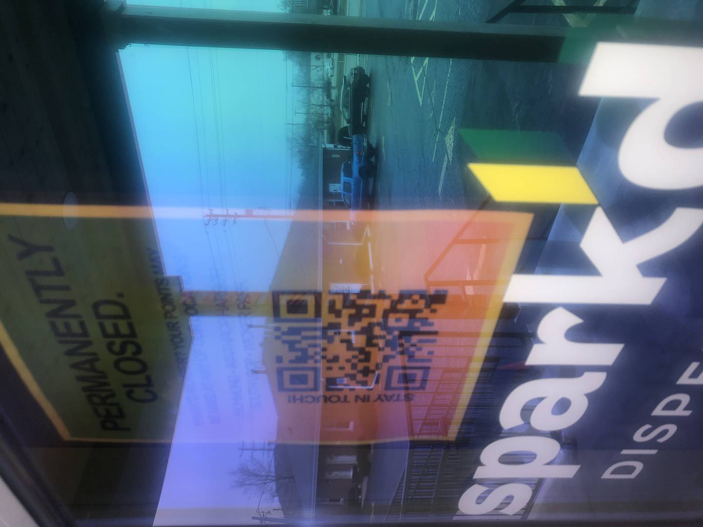 A sign announcing the Spark'd Dispensary in Crystal Lake has closed, seen here on Sunday, Dec. 29, 2024, is hard to read through an iridescent film on the door at  330 N. Route 31.
