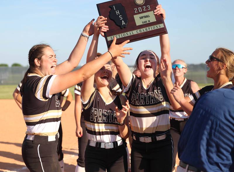 Sycamore players hoist the sectional championship plaque after their Class 3A sectional championship win over Sterling Friday, June 2, 2023, at Belvidere North High School.