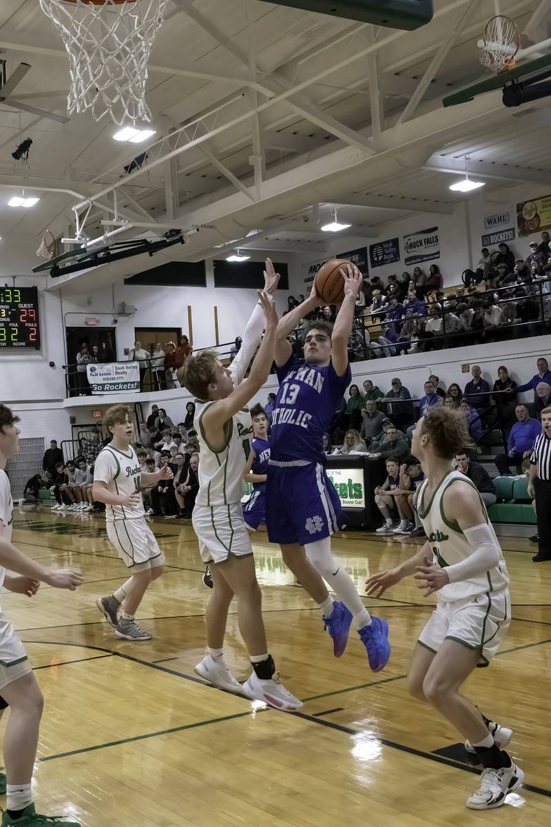 Newman's Nolan Britt (13) shoots over Rock Falls' Aydan Goff during their nonconference game Wednesday, Feb. 15, 2023 at Tabor Gym.