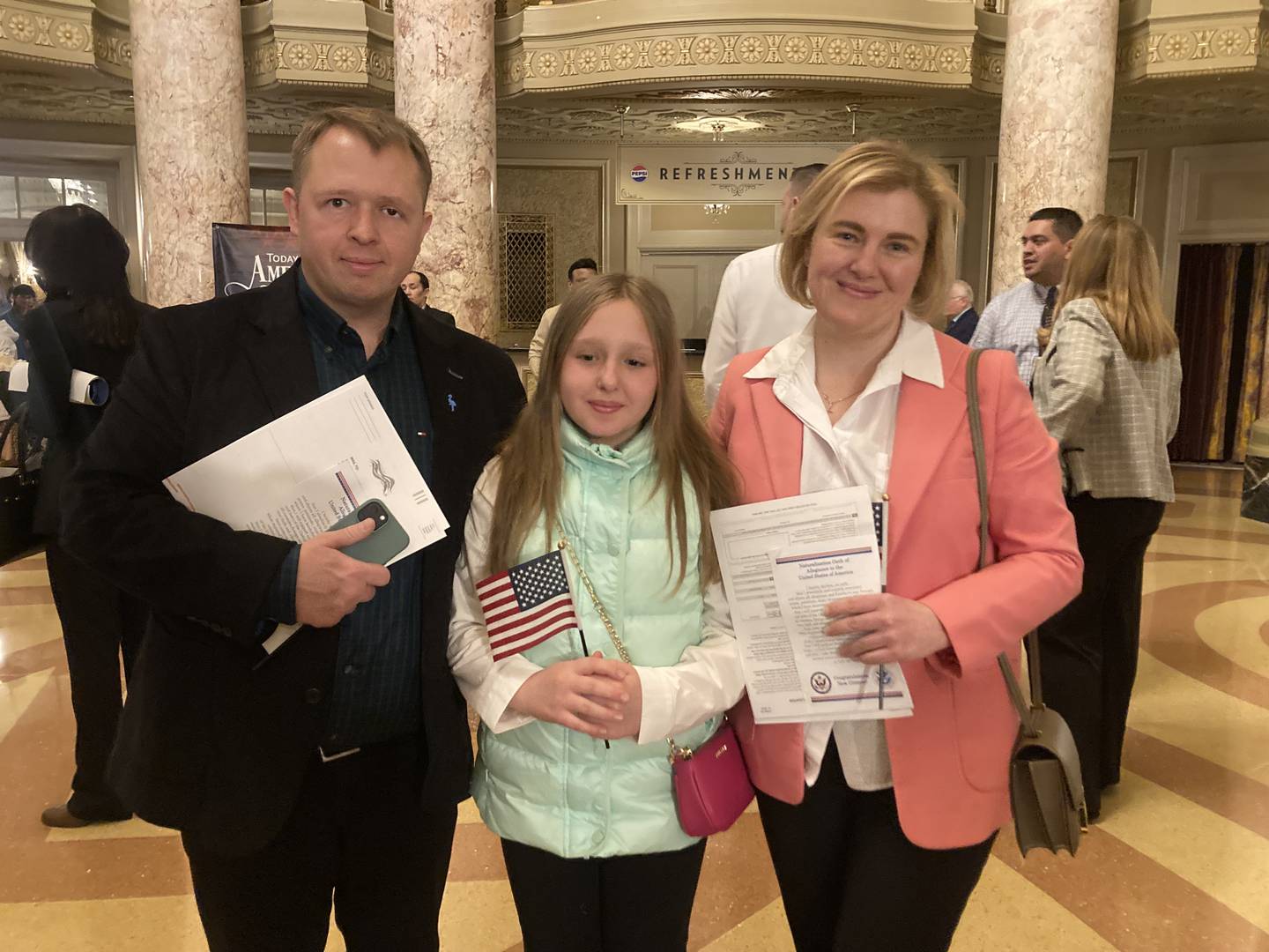Ukrainian immigrants Anton and Oksana Kukharenko and their daughter Anhelina took the oath of citizenship together at the Rialto Square Theatre in Joliet on April 17, 2025.