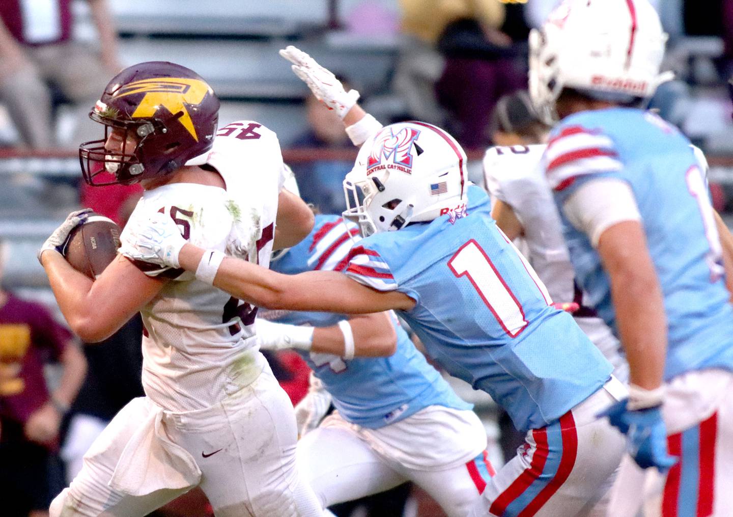 Richmond-Burton’s Riley Shea sprints with the ball past Marian Central’s Max Kinney in varsity football at George Harding Field on the campus of Marian Central High School in Woodstock on Friday, August 29, 2025.
