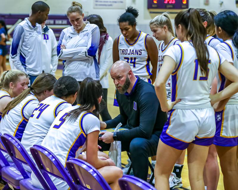 Downers Grove North's head coach Stephan Bolt gathers the team during a timeout in their basketball game versus Downers Grove South.  Dec 16, 2023.