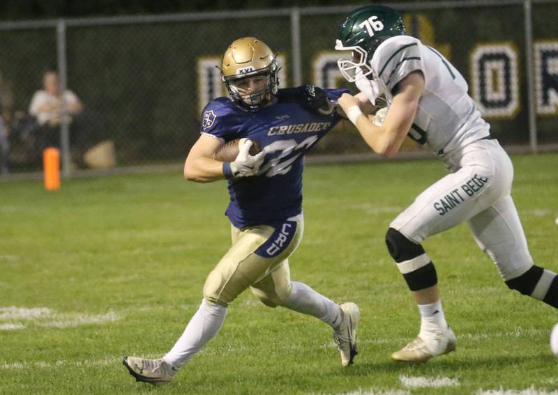 St. Bede's Kahne Gentert tugs on the jersey of Marquette's Grant Dose to try to bring him down on Friday, Sept. 26, 2025 at Gould Stadium in Ottawa.