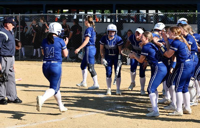 Princeton's Izzy Gibson is greeted home by a welcoming party after belting a home run in Friday''s regional semifinals at Prather Field. She powered the Tigresses to a 9-6 win.