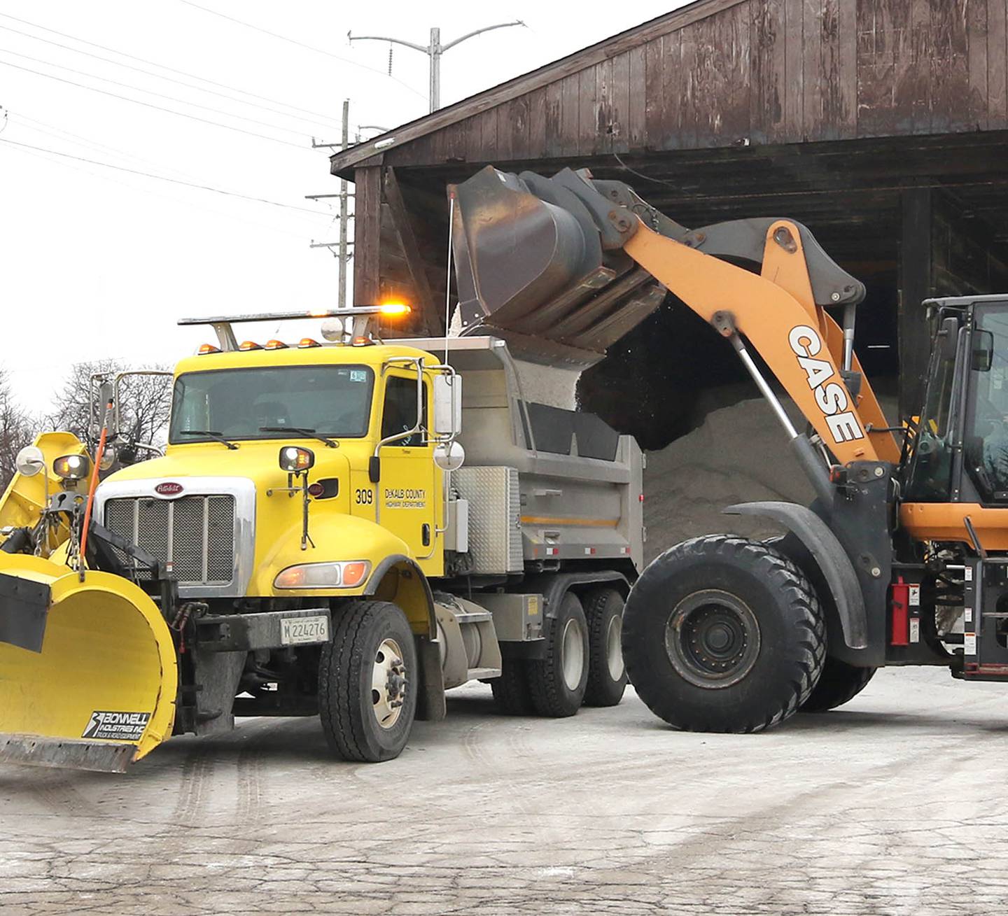 A loader pours salt into a snowplow Tuesday, Dec. 20, 2022, at the DeKalb County Highway Department location in DeKalb. A significant winter storm is expected Thursday and Friday that will blanket the area with several inches of snow.