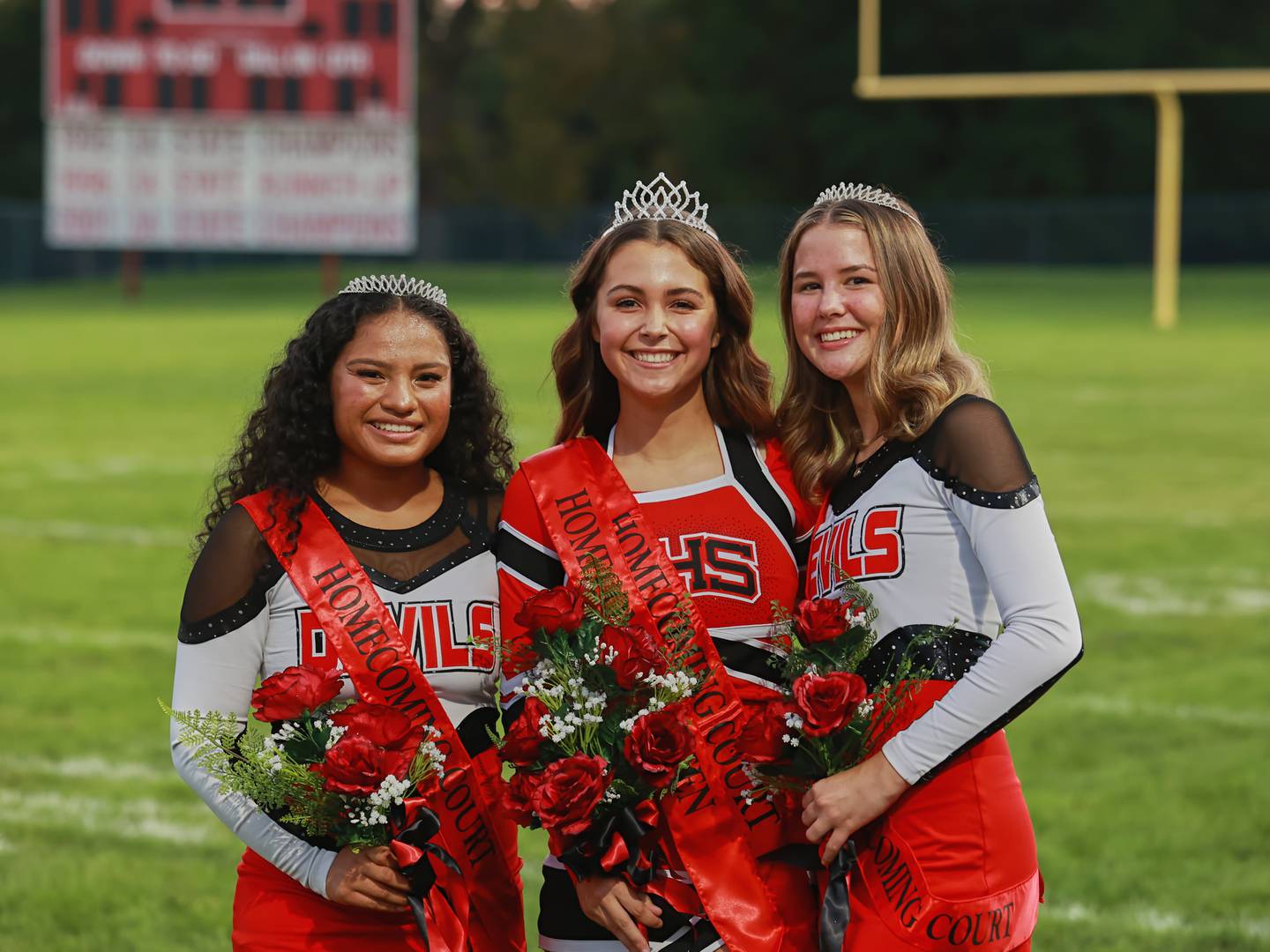 (From left) Angela Garcia-Guerrero first runner-up; Cecilia Verucchi queen and Kassi Roof second runner-up pose for a homecoming court photo Friday, Sept. 29, 2023, during Hall's homecoming football game.
