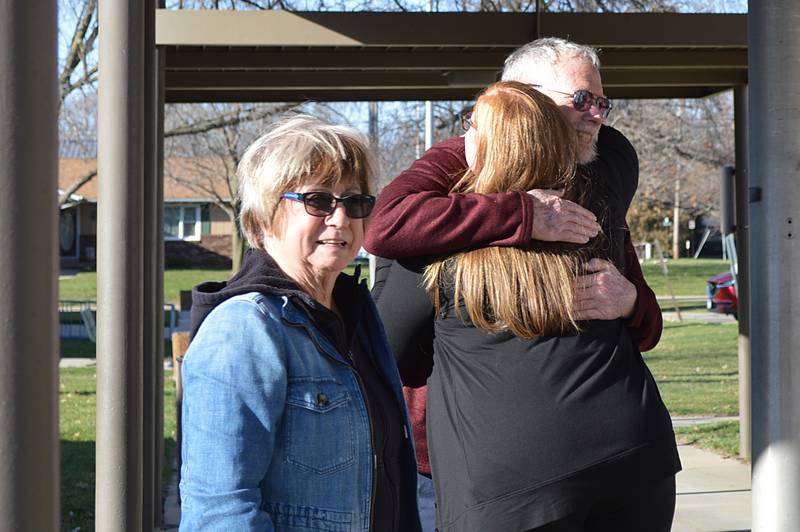 Whiteside County 911 dispatcher Tara Baumgartner hugs Tim Isaac, of Rockford, prior to the Tuesday, March 19, 2024, Rock Falls City Council meeting while his wife, Linda Isaac, stands nearby. Baumgartner assisted in getting emergency personnel to the Isaacs when Tim Isaac suffered cardiac arrest while driving on Feb. 14.