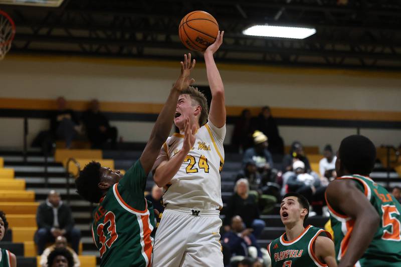 Joliet West’s Ryan Lipke takes the contested shot against Plainfield East on Friday, Dec. 19, 2025 in Joliet.
