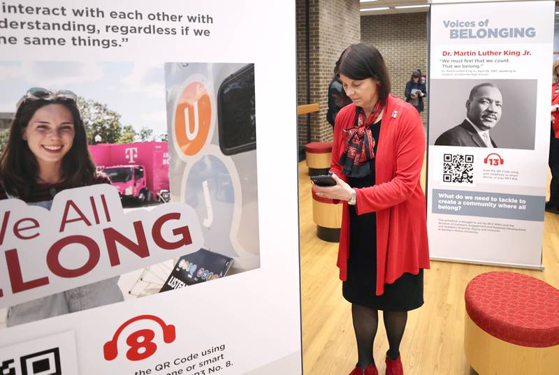 Northern Illinois University President Lisa Freeman pulls up the audio on her phone for one of the panels during the opening reception for the Voices of Belonging exhibit Thursday, March 31, 2022, in Founders Memorial Library at NIU in DeKalb. The exhibit is an interactive audio experience promoting acceptance and understanding.