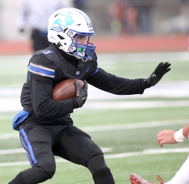 St. Charles North's Anthony Taormina (5) blocks in the first half while carrying the ball during their 7A quarterfinal game against St. Rita in St. Charles on Saturday, Nov. 12, 2022.