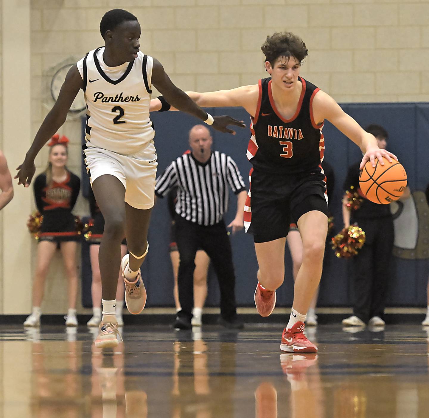 Batavia’s Jax Abalos dribbbles up court as Glenbard North’s Oturo Redento stays with him in the Class 4A Geneva boys basketball regional semifinal game on Wednesday, Feb. 26, 2025.