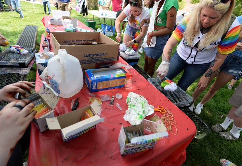 Kim Gigante of Elk Grove Village makes a tie-dye t-shirt during the Downers Grove Pride Fest Saturday June 7, 2025.