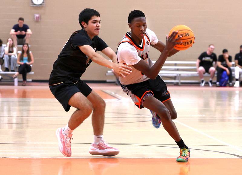DeKalb’s Gabriel Crump drives by a defender Friday, June 20, 2025, during their game against Streamwood in the DeKalb Live summer tournament at DeKalb High School.