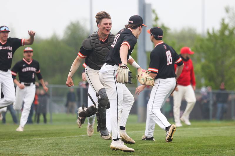 Lincoln-Way West catcher Kaleb Wilkey celebrates with Colton Kachinsky after a game ending play at the plate for a 4-3 extra-inning win over Lincoln-Way Central on Monday, May 8, 2023 in New Lenox.