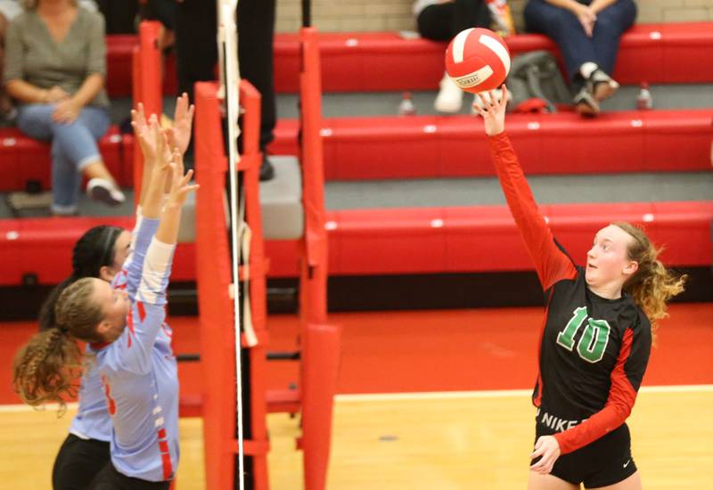 L-P's Katie Sowers sends a spike past Ottawa's Chey Joachim and teammate Ayla Dorsey on Thursday, Sept. 21, 2023 at Kingman Gym.