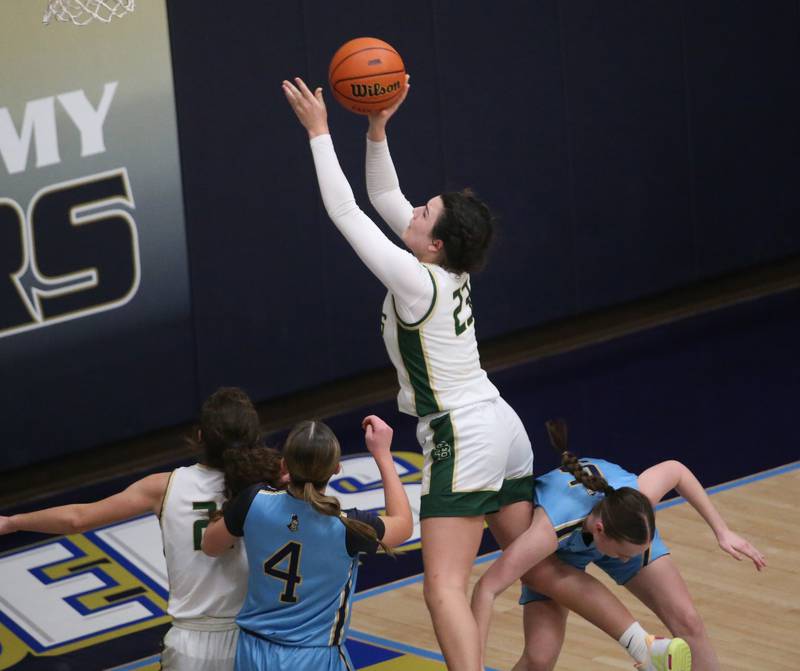 St. Bede's Ali Bosnich eyes the hoop as she is couled by Marquette's Chloe Larson late in the fourth quarter during the Class 1A Regional semifinal game on Monday, Feb,. 12, 2024 in Bader Gym.