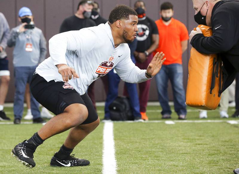 Christian Darrisaw runs a drill Virginia Tech pro day, attended by NFL football scouts, in Blacksburg, Va., Friday, March 26, 2021. (AP Photo/Matt Gentry)