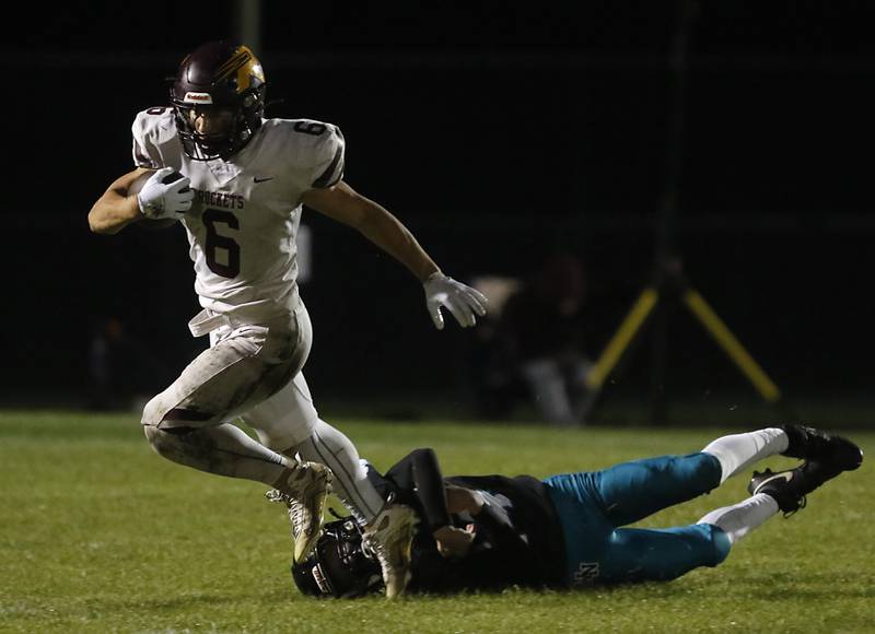 Richmond-Burton's Hunter Carley avoids the tackle attempt of Woodstock North's Conlan Leese during a Kishwaukee River Conference football game on Friday, Oct. 10, 2025, at Woodstock North High School.