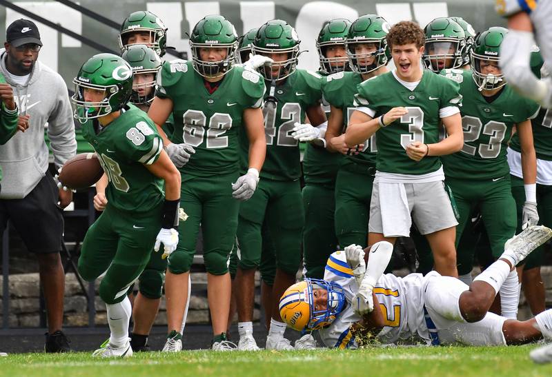 Glenbard West wide receiver Brian Clohecy (88) escapes Lyons Township tackler Shane Harris (on ground) after a reception during a game on Sep. 16, 2023 at Glenbard West High School in Glen Ellyn.