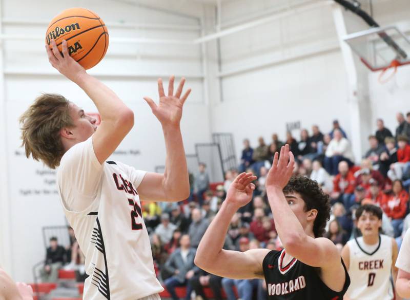 Indian Creek's Parker Murry lets go of a shot over Woodland's Brezdyn Simons during the Class 1A Sectional Semifinal game on Wednesday, March 4, 2026 at Amboy High School.