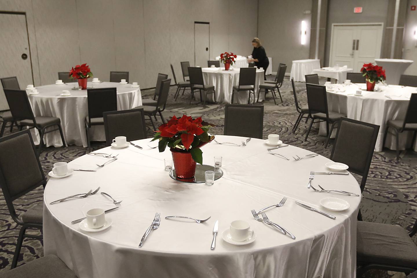 Mary Giersch sets up at the ballroom Friday, Dec. 16, 2022, at the Holiday Inn, 800 S. Route 31 in Crystal Lake, for a Christmas party at the hotel. In-person holiday parties have returned this year after several years of the COVID-19 pandemic curtailing parties.