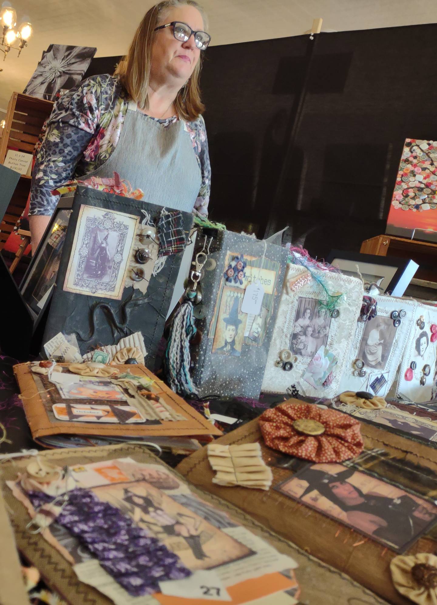 Nancy Nieslawski of La Salle listens to a customer browsing her custom-crafted journals Saturday, Oct. 22, 2022, during the Witches Day Out market at Pitstick Pavilion in Ottawa.