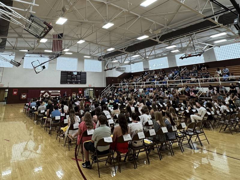The students being honored at Morris Community High School's honors night on Wednesday, May 7 listen to Morris graduate Chris Gallick share his experiences.