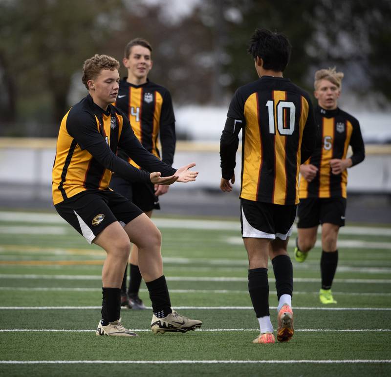 Herscher's Dawson Langlois, left, congratulates teammate Luis Parra, right, on a goal in a regional match-up with Bishop McNamara on Tuesday, October 21, 2025.