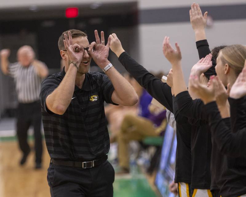 Herscher Head Coach, Tim McElroy celebrates the teams first basket of the year with the bench during the Falcon-Irish Girls Basketball Tournament on November 19, 2024 at Seneca High School.