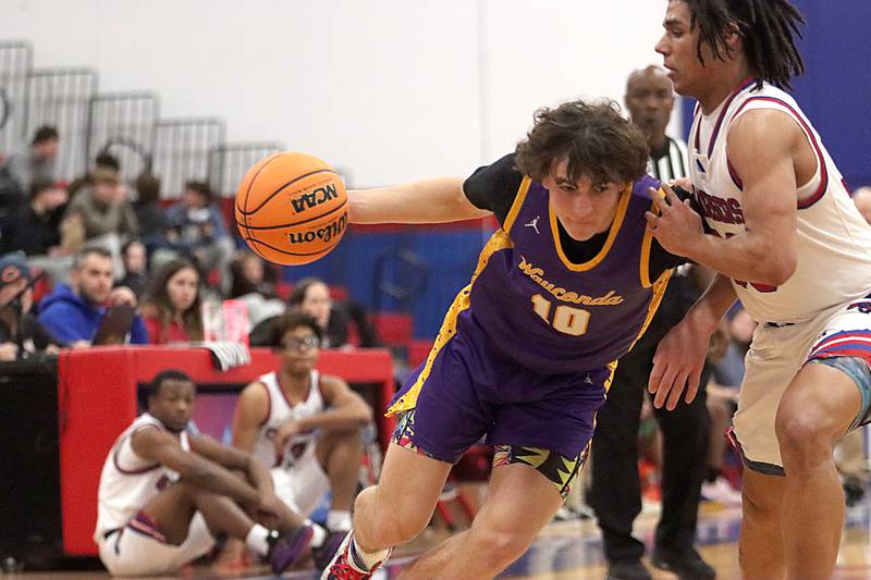 Dundee-Crown’s Anthony Spain, right, guards Wauconda’s Tony Salemi in varsity basketball Friday, Dec. 20, 2024 at Dundee-Crown High School in Carpentersville.