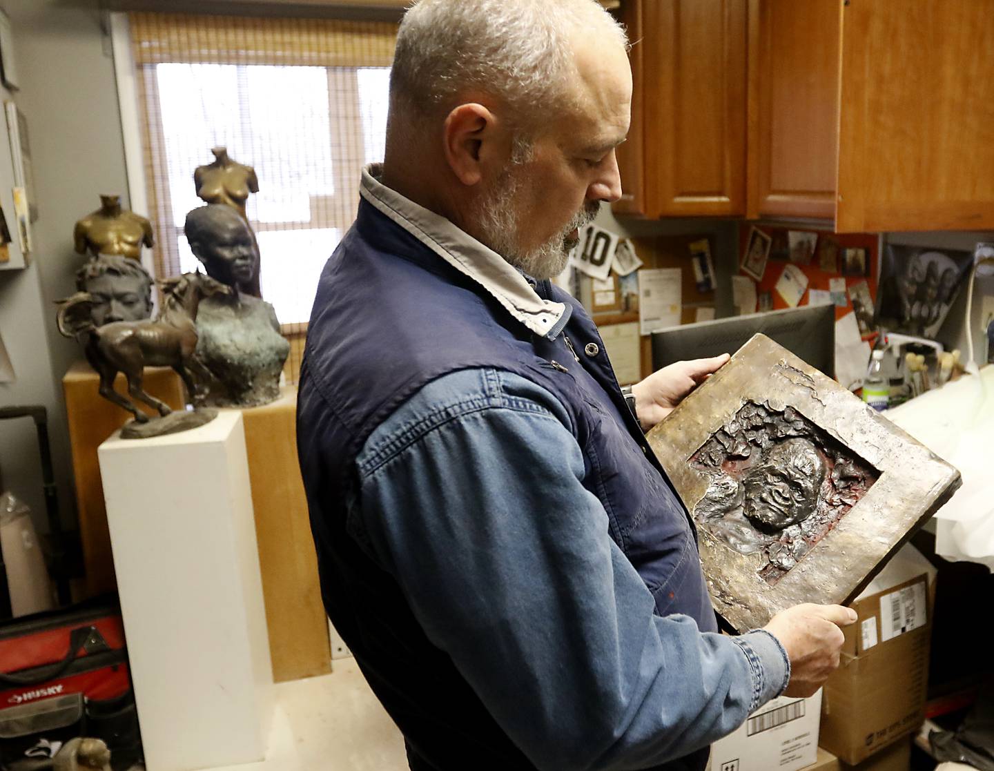 Erik Blome looks at a sculpture, that he made in Africa, in his studio in Woodstock on  Dec. 27, 2022.