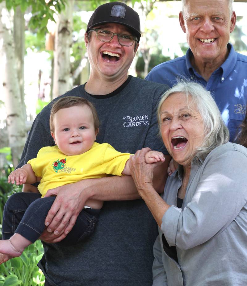 Joan Barczak, (bottom right) co-owner of Blumen Gardens, has some fun with her grandson Clay Mandeville as husband Joel Barczak, (top right) co-owner, and son-in-law Keith Mandeville, manager, look on Wednesday, June 19, 2024, at the store in Sycamore.