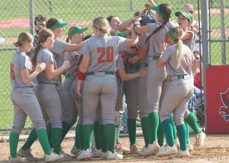L-P's Anna Riva is greeted by her teammates at home plate after hitting a home run against Ottawa on Tuesday, April 14, 2026 at Ottawa High School.