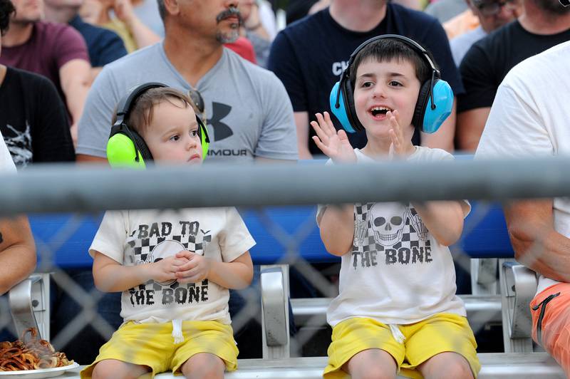 Two-year-old Ferris Runnion of Woodridge doesn't know what to make of the loud trucks in the Sandwich Fair's tractor pull, while his brother Owen, 5 loves it, Thursday, Sept. 5, 2024, at the fairgrounds in Sandwich.