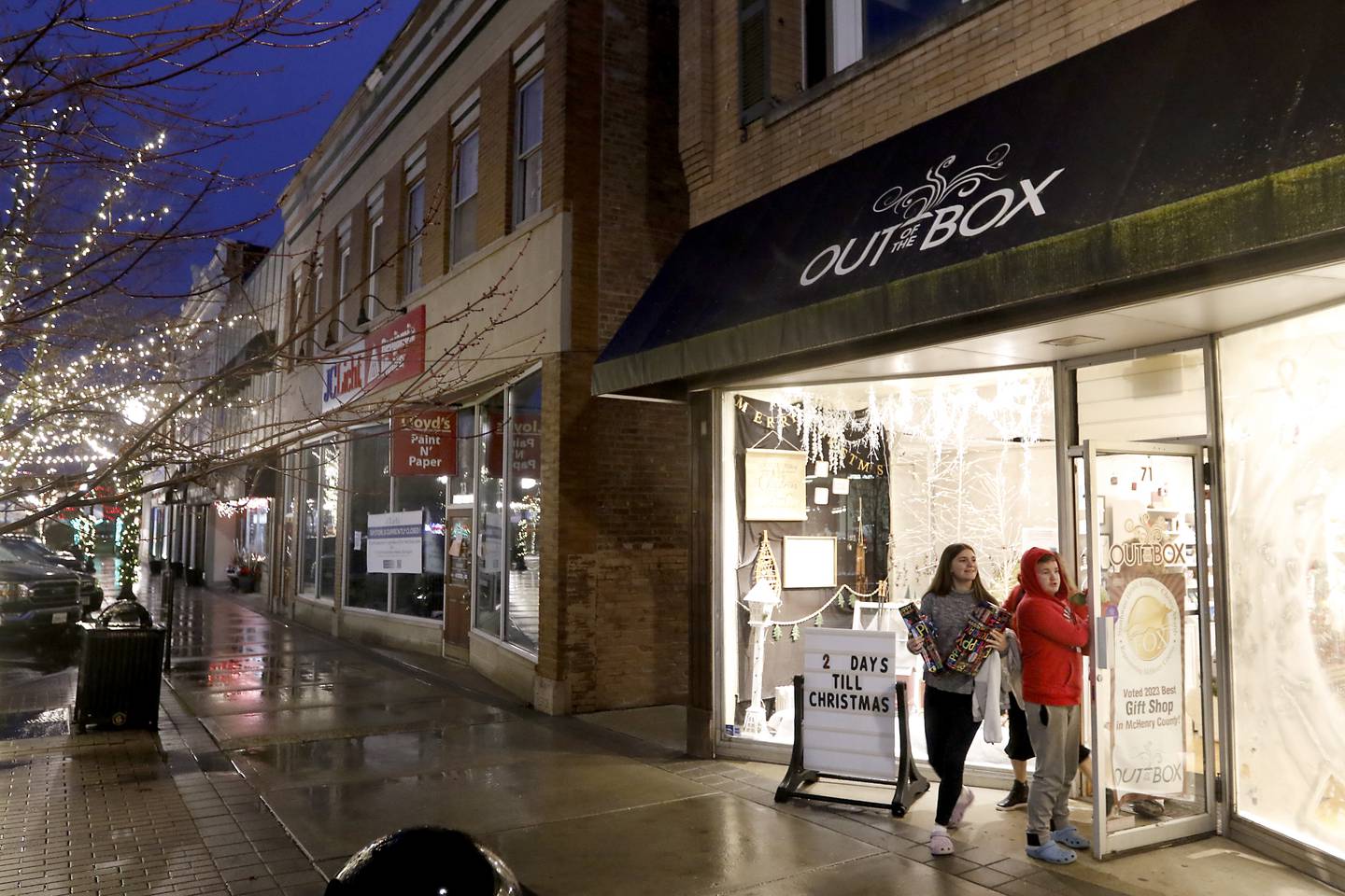 People leave Out of the Box after shopping on Friday, Dec. 1, 2023, in Downtown Crystal Lake. Out of the Box has recently reopened after losing all of its inventory after a major fire in an adjacent building during the summer.