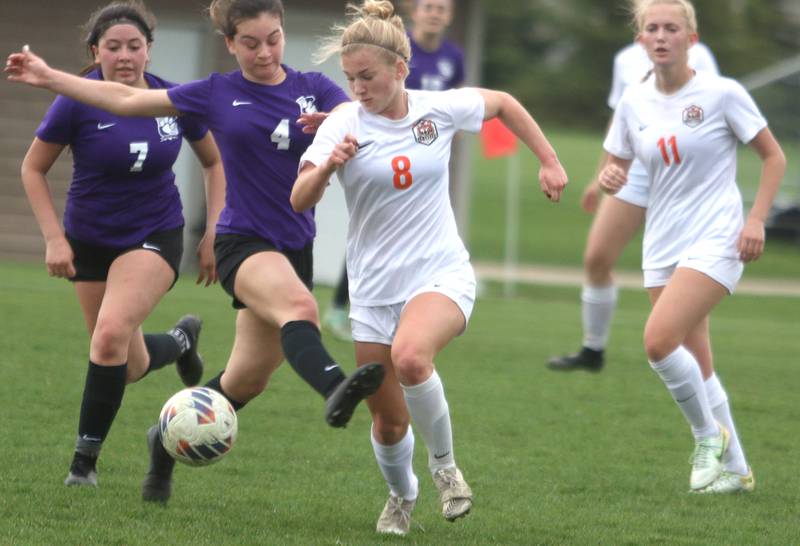 Hampshire’s Adilene Perez, center left, battles Crystal Lake Central’s Olivia Anderson, center right, in varsity soccer at Hampshire Thursday.