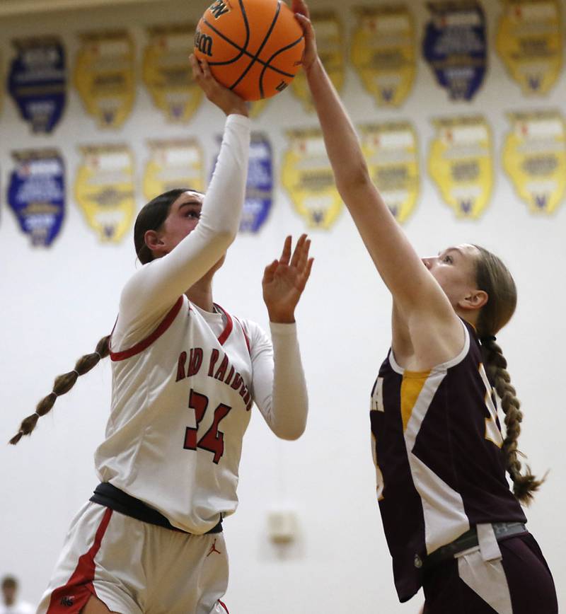 Huntley's Ava Mcfadden tries to shoot the ball against Loyola Academy's Emily Naraky during the IHSA Class 4A Gurnee Warren Supersectional girls basketball game on Monday, March 3, 2025, at Warren Township High School in Gurnee.