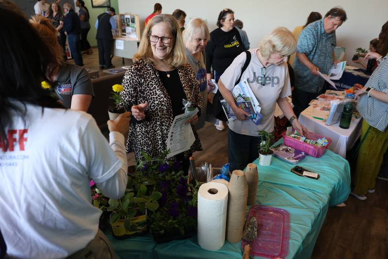 Residents take free plants at the Green Escape Earth Day Event on Wednesday, April 22, 2026 in Joliet.