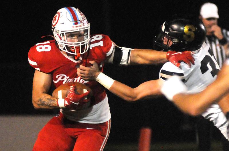 Ottawa senior Jack Pongracz (18) brushes off Sycamore's Cooper Bode (31) on Friday, Sept. 26, 2025 at King Field.