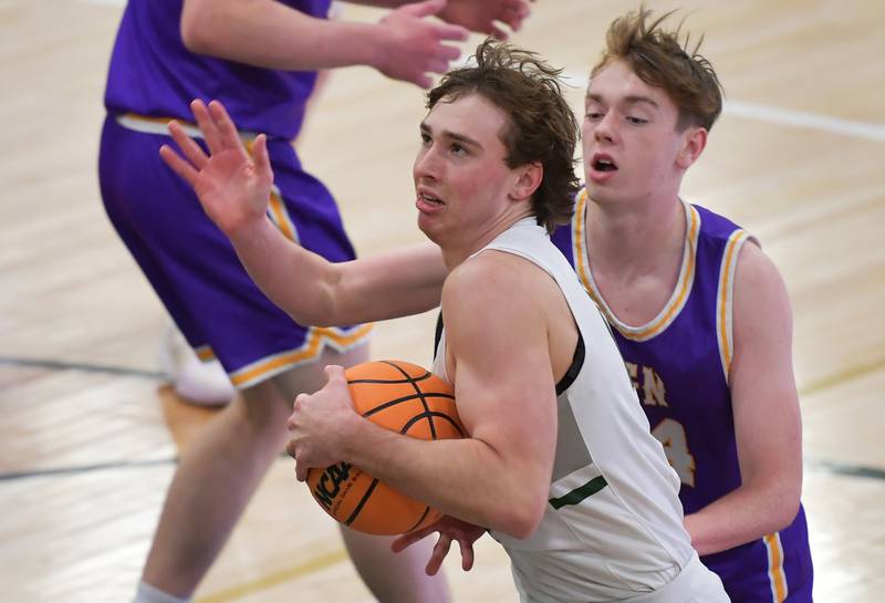 Glenbard West’s Jacob Harvanek goes to the basket in front of Downers Grove North’s Owen O'Reilly (right) during a game on January 23, 2026 at Glenbard West High School in Glen Ellyn.
