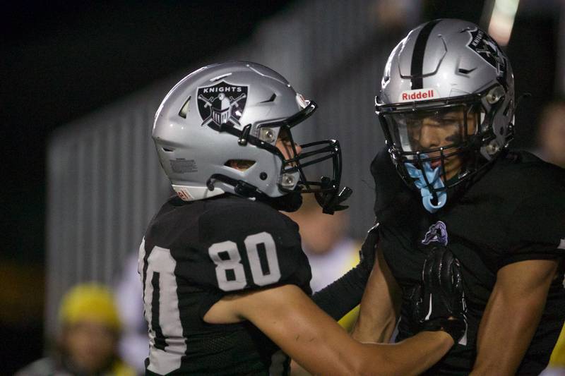 Kaneland's  Dylan Sanagustin (80) celebrates a touchdown by Evan Frieders (1) against Morris on Friday, Sept. 8, 2023 in Maple Park.